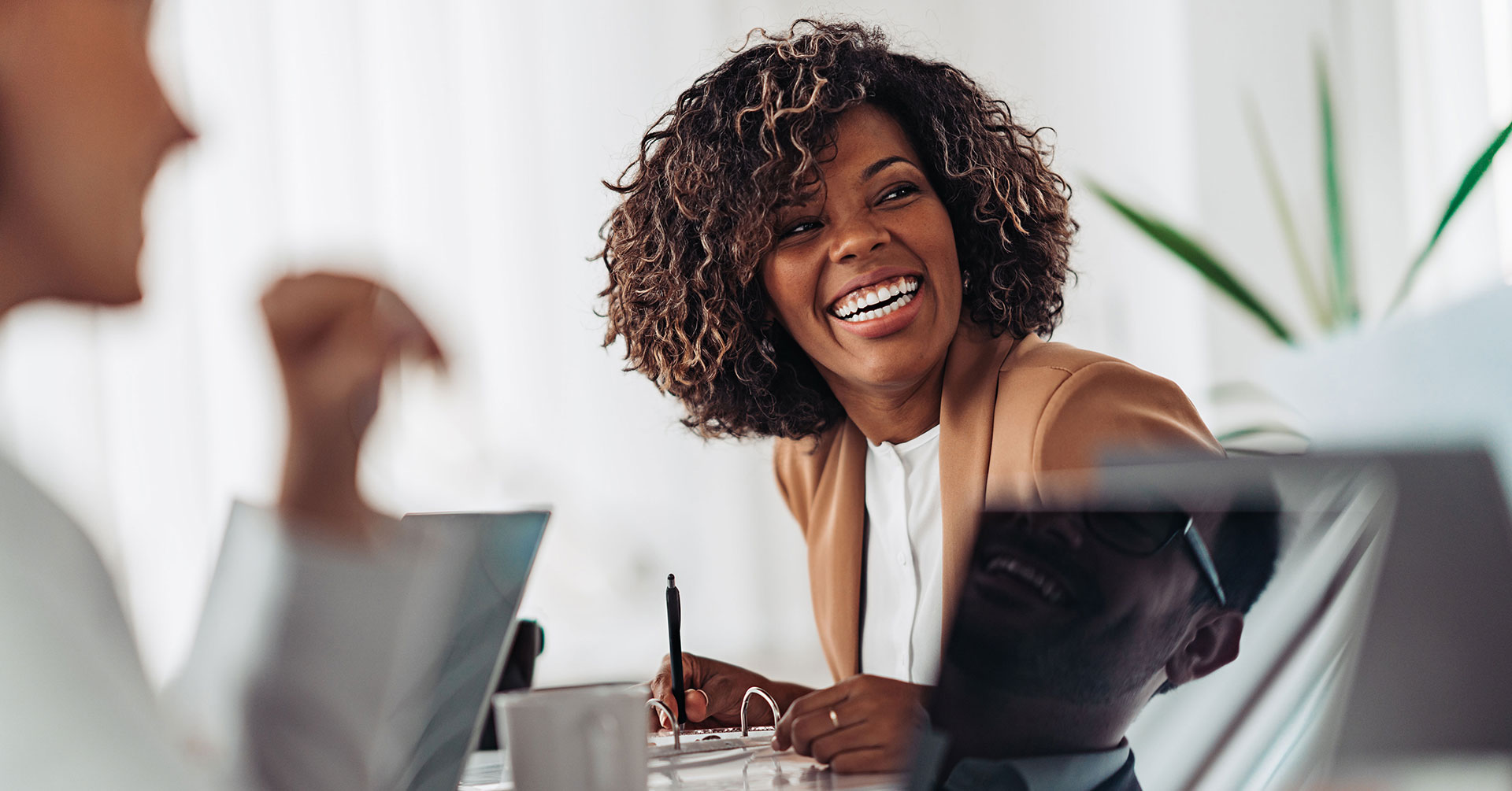 Woman Smiling Female smiling in a meeting with healthcare practice clients