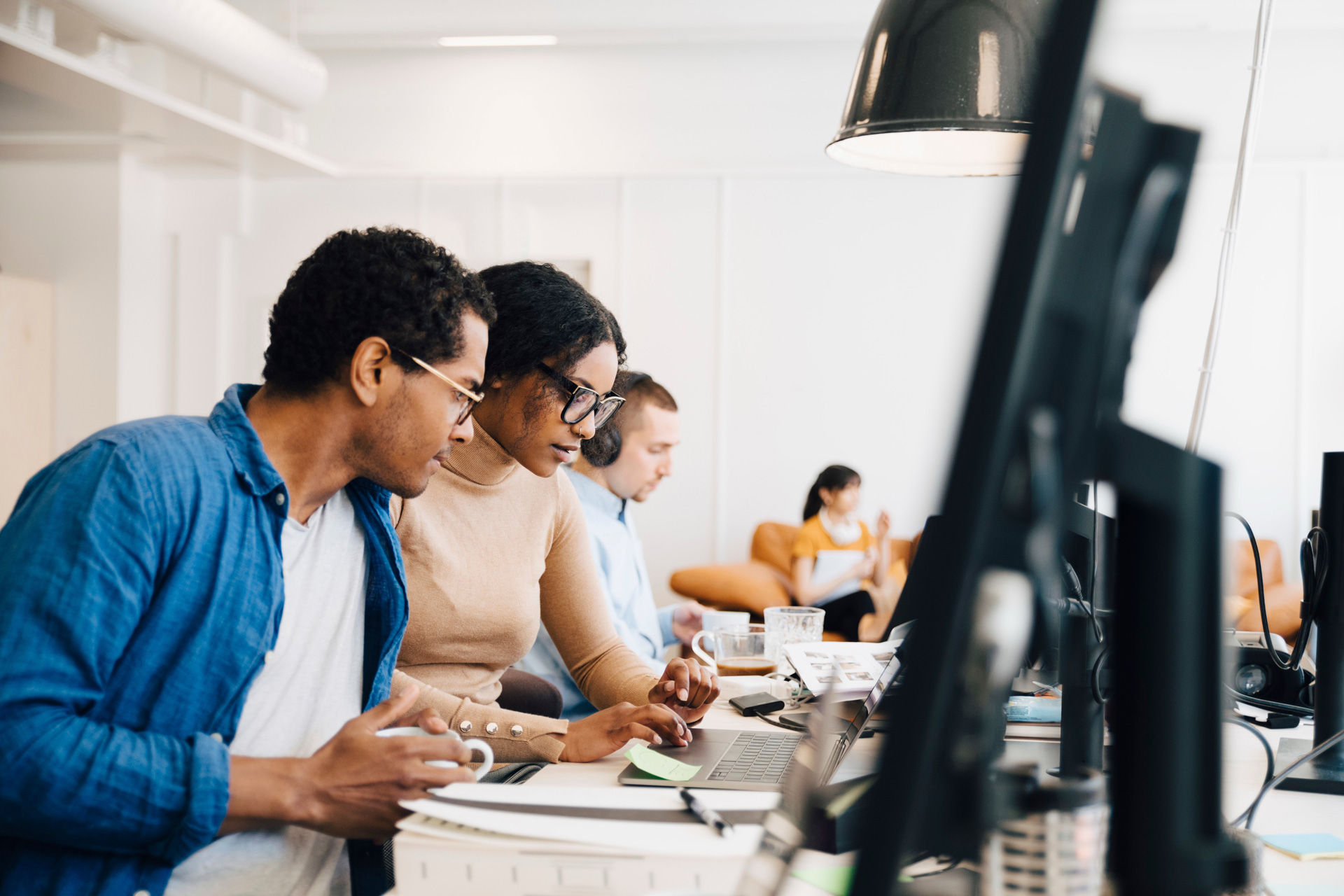 Team of IT and security consultants working in the office on their monitors