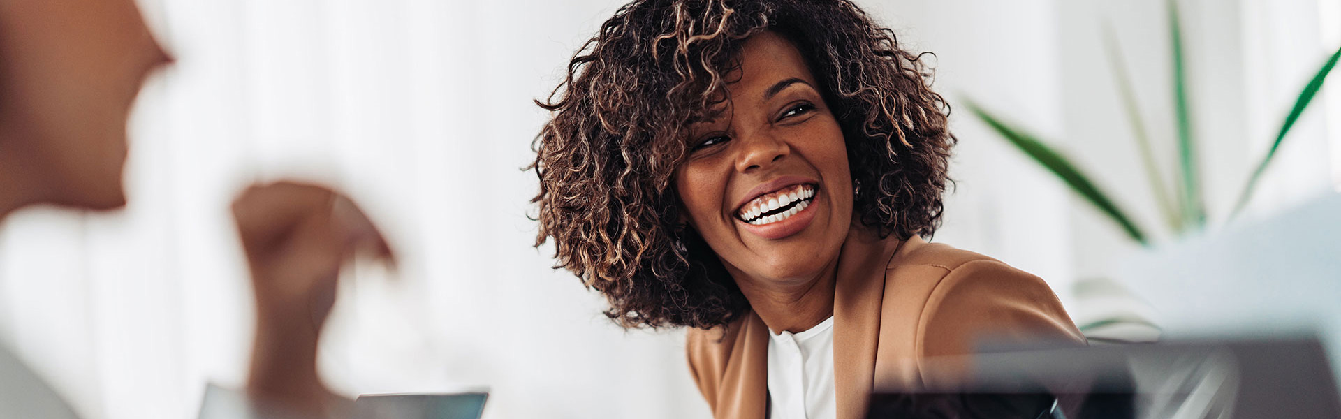 African American female smiling in a meeting representing a Fractional Executive Leader