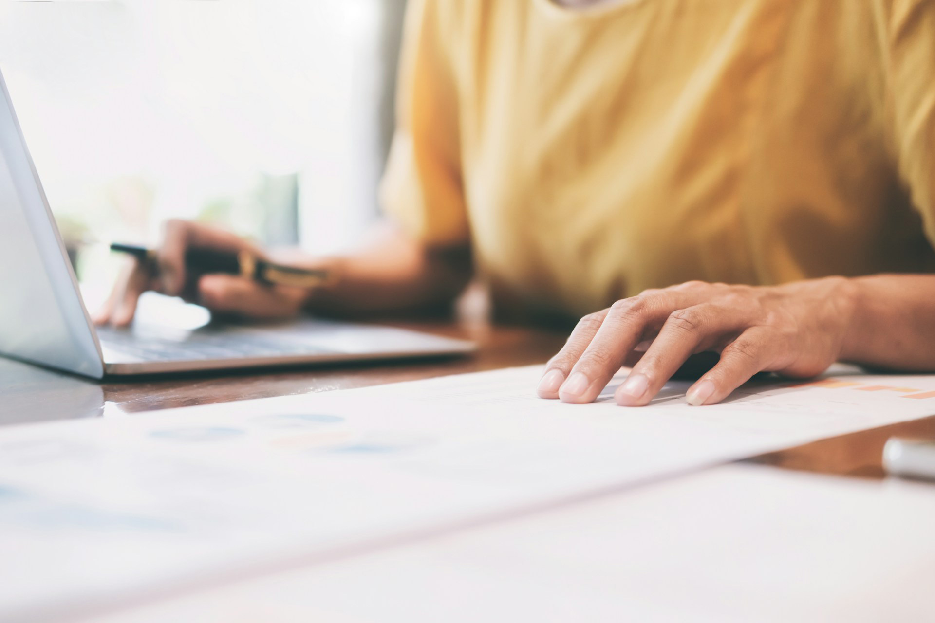 Hands of a person doing bookkeeping on their laptop