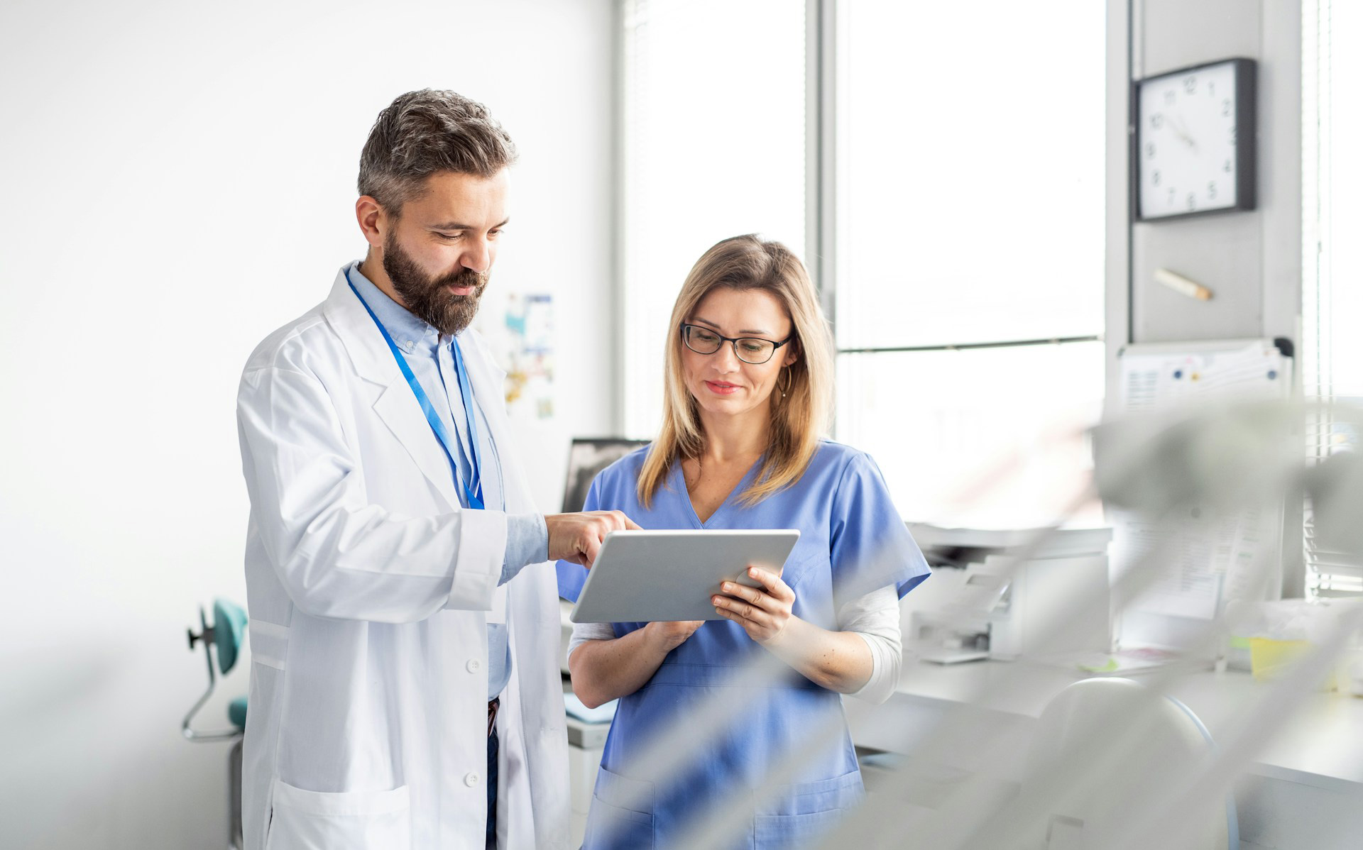 Male and female doctor reviewing performance in the healthcare practice